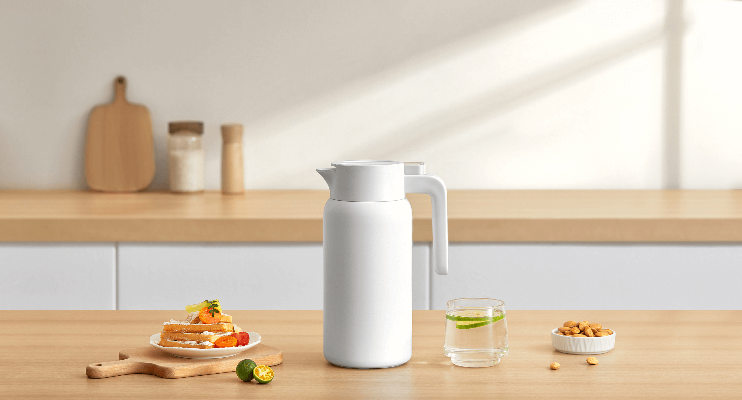A white Xiaomi insulated kettle on a sunlit breakfast table